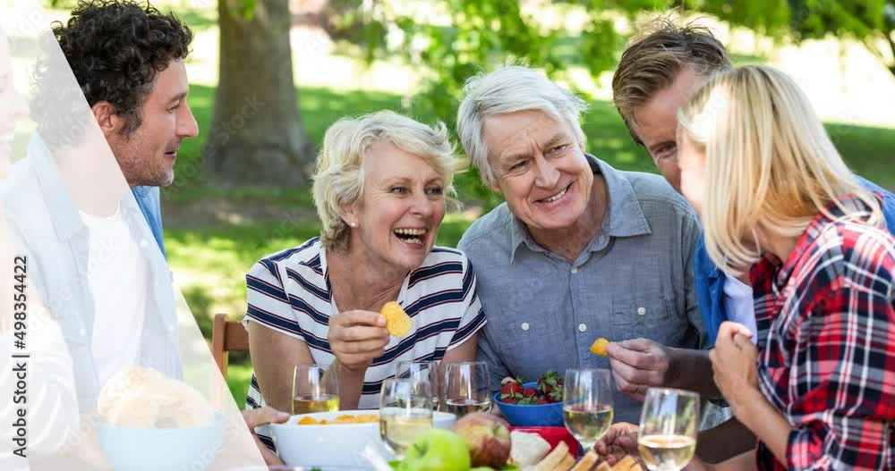 Animation of picnic basket over happy caucasian family having picnic in park Animation of picnic basket over happy caucasian family having picnic in park