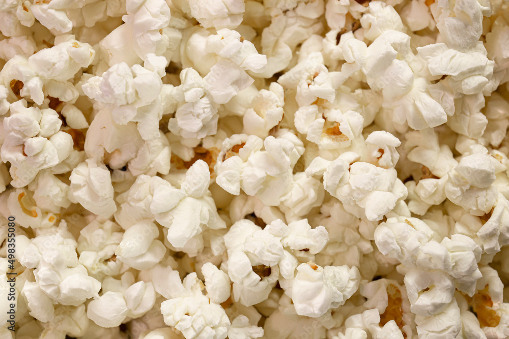 Scattered popcorn. Close-up picture of fluffy salted popcorn. background texture. View from above - Top view. Scattered popcorn. Close-up picture of fluffy salted popcorn. background texture. View from above - Top view.