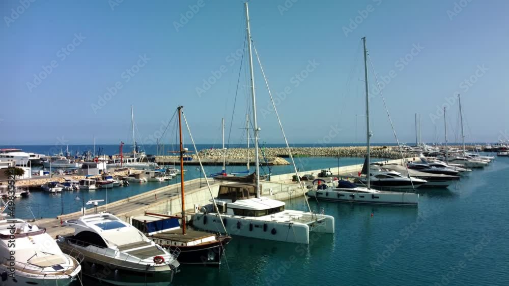Drone flying over ships, yachts and boats in the old port in Limassol in Cyprus on a sunny spring day. Drone flying over ships, yachts and boats in the old port in Limassol in Cyprus on a sunny spring day.