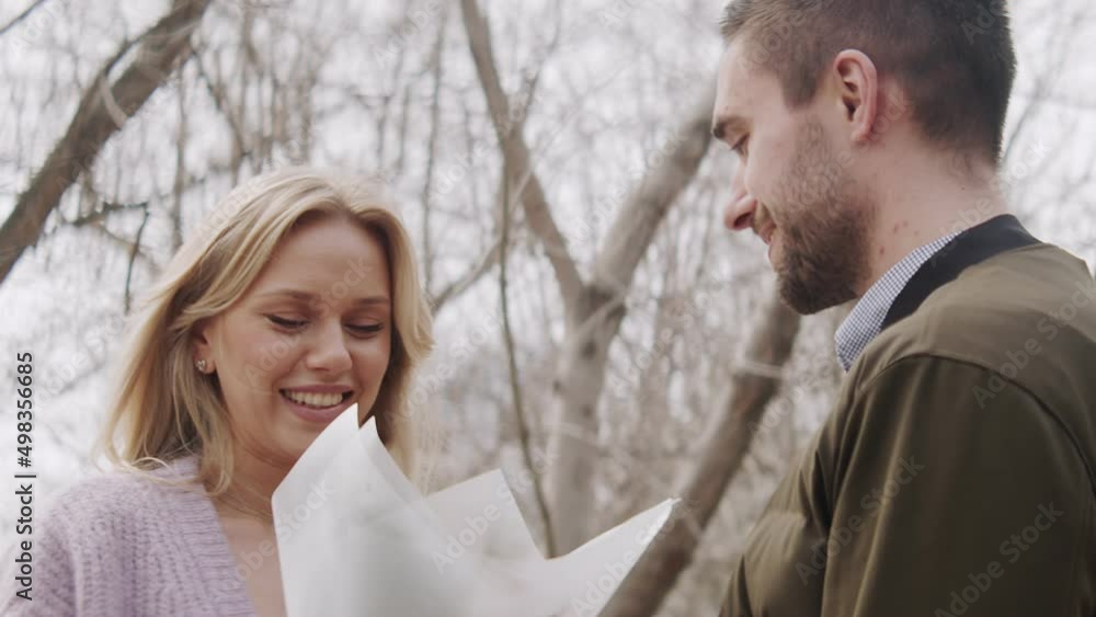 A young man gives a bouquet of flowers to a woman, the first date. Love of a man and a woman A young man gives a bouquet of flowers to a woman, the first date. Love of a man and a woman