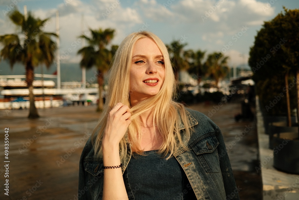 Portrait of a beautiful smiling girl on the background of a sea landscape. High quality photo Portrait of a beautiful smiling girl on the background of a sea landscape. High quality photo