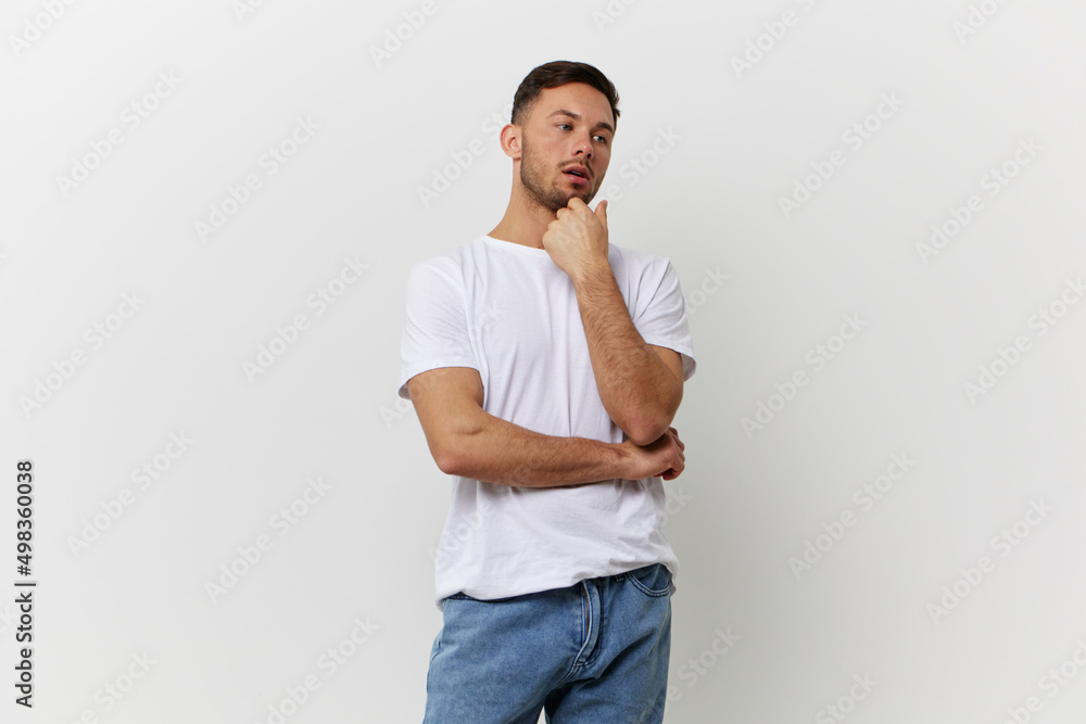 Pensive thoughtful young tanned handsome student man in basic t-shirt look aside posing isolated on over white studio background. Copy space Banner Mockup. People emotions Lifestyle concept Pensive thoughtful young tanned handsome student man in basic t-shirt look aside posing isolated on over white studio background. Copy space Banner Mockup. People emotions Lifestyle concept