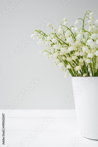 spring flowers lily of the valley in white vase