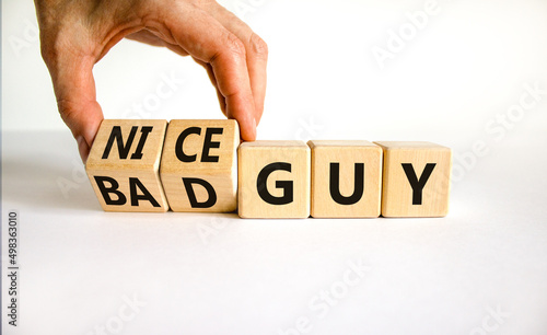 Nice or bad guy symbol. Businessman turns cubes and changes concept words Bad guy to Nice guy. Beautiful white background. Business psychological nice or bad guy concept. Copy space.