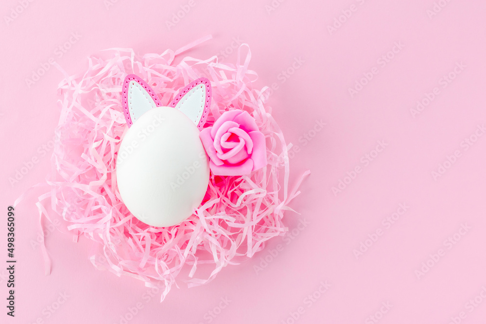 Easter egg in the nest. Easter background.Postcard with space for text in pink, toned Easter egg in the nest. Easter background.Postcard with space for text in pink, toned