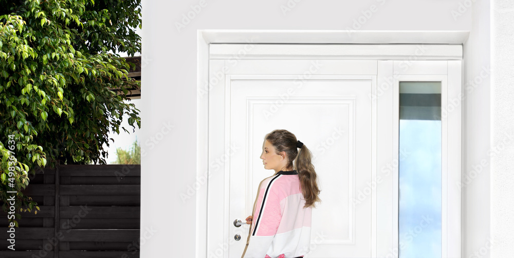 Fototapeta premium Beautiful woman opening the door of her home.