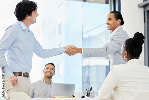 Combining talent with teamwork gets results. Shot of a group of people having a meeting and shaking hands in a modern office.