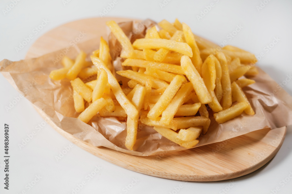french fries on a wooden plate french fries on a wooden plate