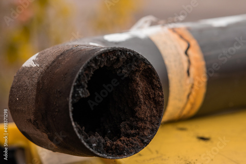 фотографія Residue or thick layer of soot after a poor combustion in a fireplace, layered on the inner part of a chimney pipe or smokestack