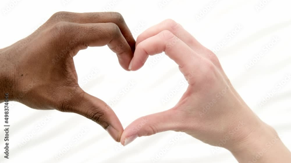 Heart from hands close up multiracial couple african man and caucasian woman lovers, Concept mixed family love on white. Heart from hands close up multiracial couple african man and caucasian woman lovers, Concept mixed family love on white.