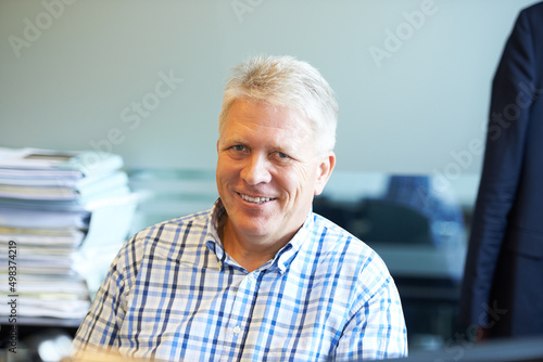 Hes got experience you can trust. Portrait of a senior businessman sitting in his office.