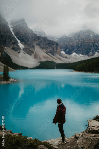 person standing on the edge of a lake