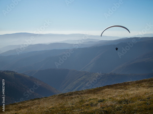 Hang-glider in the blue sky with clouds