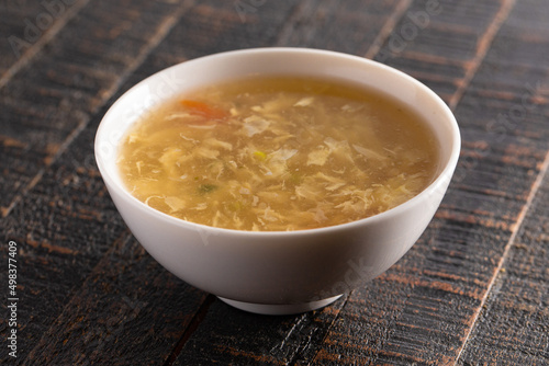 Egg drop soup isolated on a wooden table