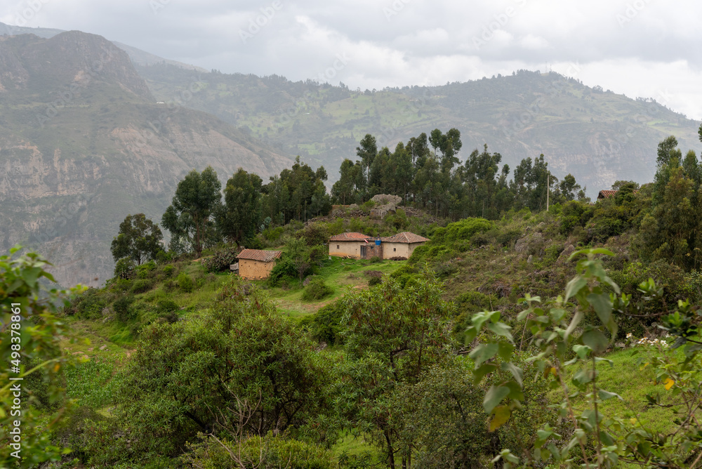Peasant house on top of a hill surrounded by mountains with vegetation. Boyacá. Colombia.