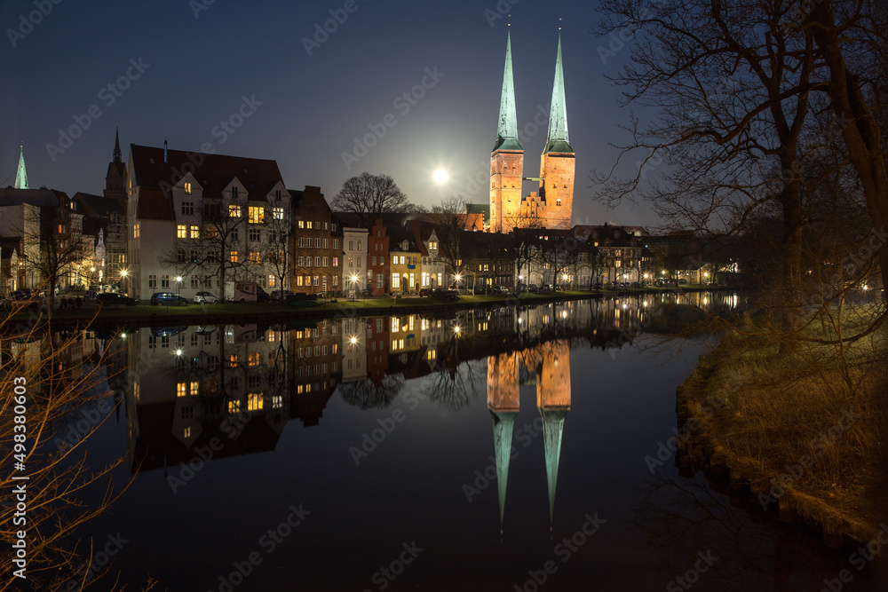 evening view of the center of Lübeck with reflection on the water surface