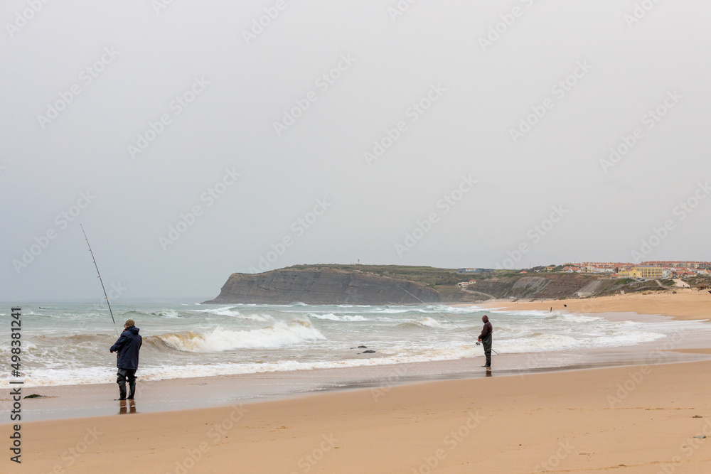 Persistent Fishermen Braving the Stormy Weather on a Portuguese Beach