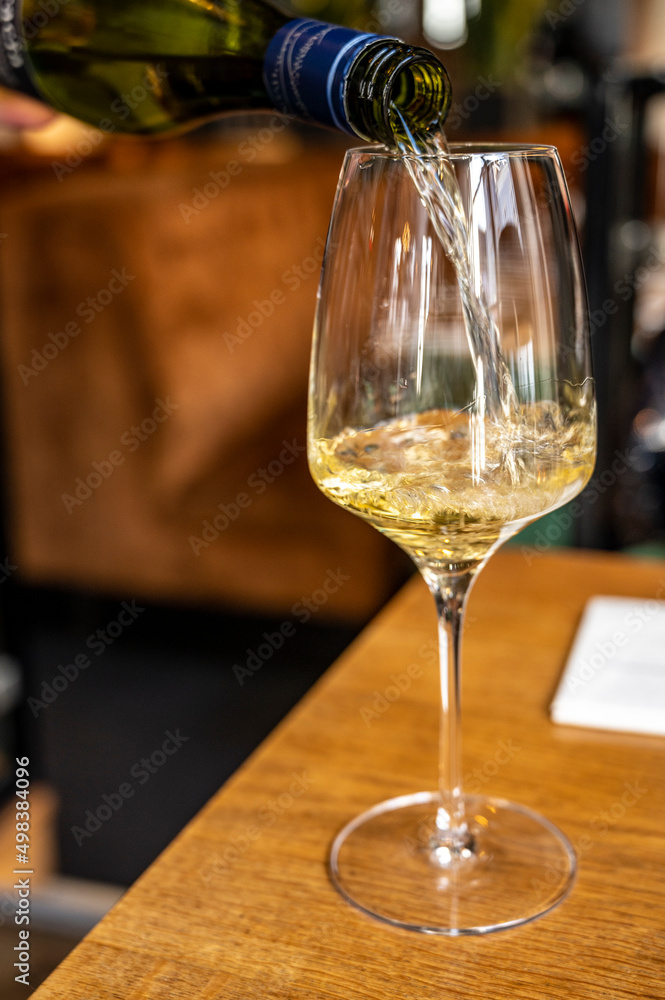 Fototapeta premium Glass of Chilean Chardonnay Viognier white wine served in restaurant
