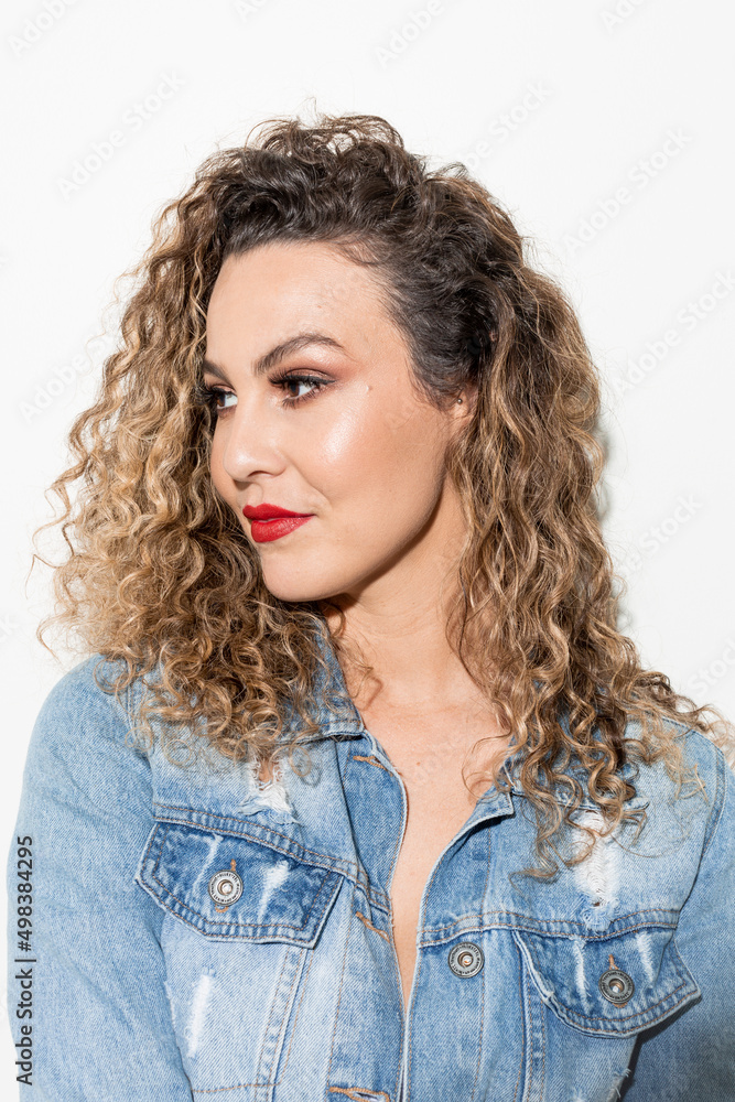 Studio shot of proud young girl with perfect light brown skin and beautiful curly hair in empowerment pose on a white background. Studio shot of proud young girl with perfect light brown skin and beautiful curly hair in empowerment pose on a white background.