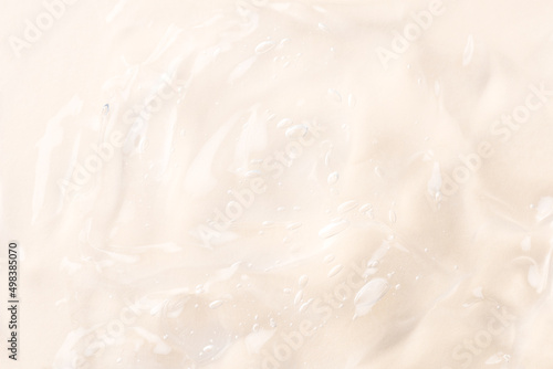 Closeup beige pink moisturizer, hygiene product, alcohol gel, liquide serum, shower gel, hand sanitizer, colored cream texture product sample with bubbles. Transparent abstract background