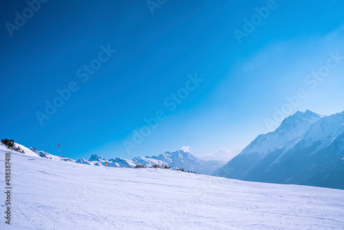 Scenic view of snow covered landscape. Ski tracks on alps mountain against sky. Concept is beautiful nature. © Aerial Film Studio
