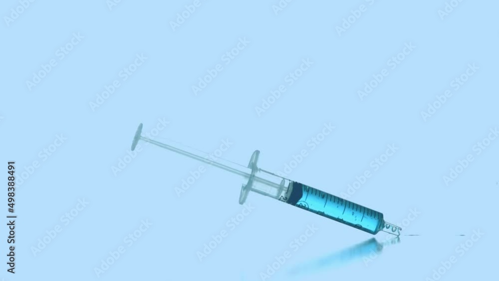 Animation of red dots over falling syringe with blue reagent Animation of red dots over falling syringe with blue reagent