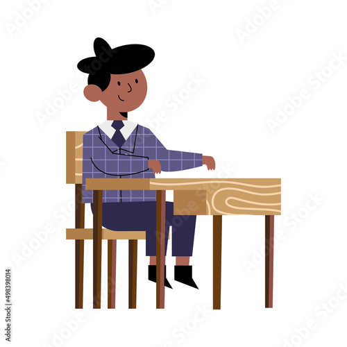 schoolboy seated in desk