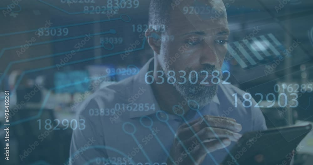 Animation of data processing over african american businessman using tablet Animation of data processing over african american businessman using tablet