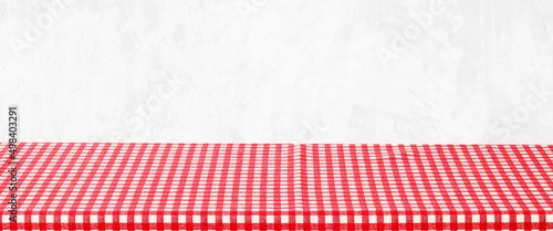 Empty table with red and white check pattern tablecloth over white wall background, banner, table top, shelf, counter design for product display montage