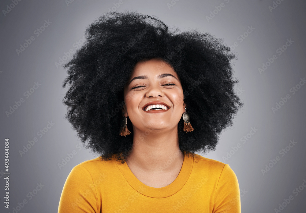 Glow with that glorious smile. Studio shot of an attractive young woman posing against a grey background. Glow with that glorious smile. Studio shot of an attractive young woman posing against a grey background.