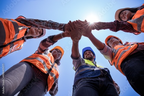 Group of multi-ethnic engineers are working together with their cheering hands.
Concept of people difference in ethnicity,Asian, African, Middle Eastern,male, female and skin color equality,Diverse.