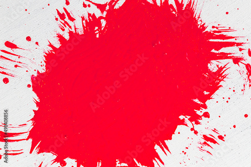 thick red acrylic paint applied in an uneven patch on a flat surface