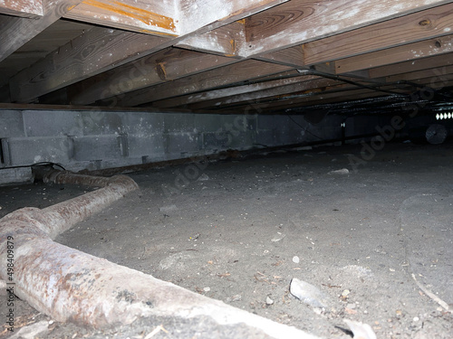 Pipe Running in Dirt Crawl Space Under House photo