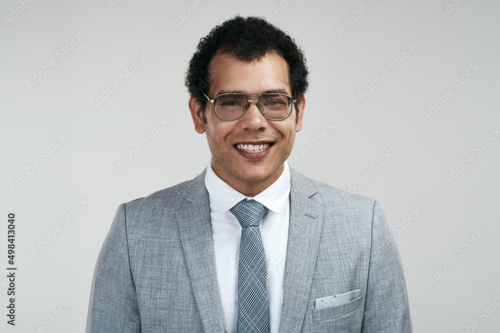 Im the owner of a successful business. Studio shot of a businessman wearing glasses while standing against a grey background. Im the owner of a successful business. Studio shot of a businessman wearing glasses while standing against a grey background.