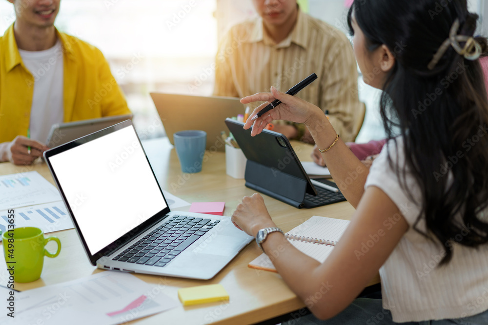 Group of young Asian business people meeting in casual wear working together on new project. Group of young Asian business people meeting in casual wear working together on new project.