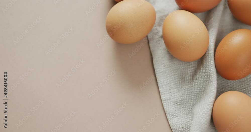 Video of overhead view of eggs and on rustic cloth on beige background Video of overhead view of eggs and on rustic cloth on beige background