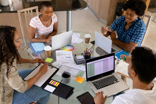 High angle view of biracial business colleagues working together at home office table photo