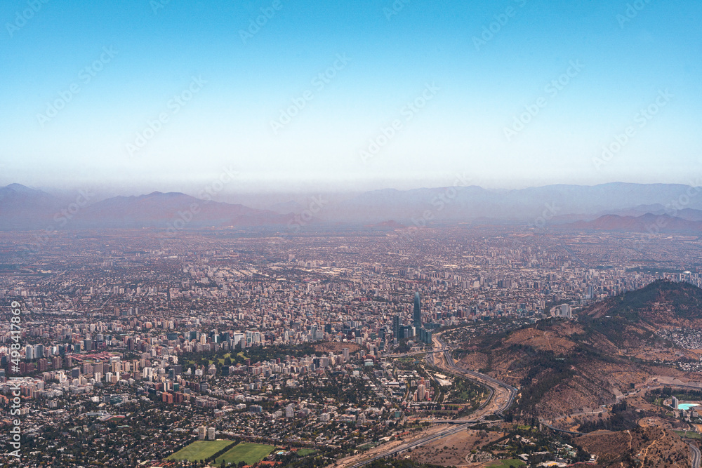Fototapeta premium Sky view of the city of Santiago during the afternoon from Maquehue hill with smog.