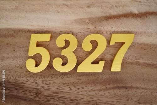 Golden Arabic numerals on a real brown and white wooden floor number ...