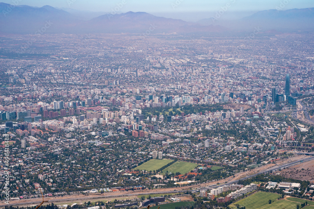 Panoramic view of the city of Santiago with smog and mountains during the afternoon from the Maquehue hill.