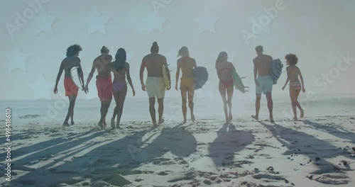 Animation of stars over back of diverse friends walking on beach with surfingboards photo