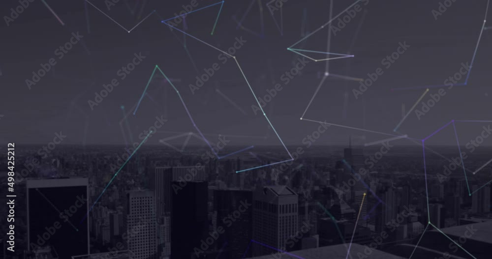 Network of connections floating against aerial view of cityscape at night