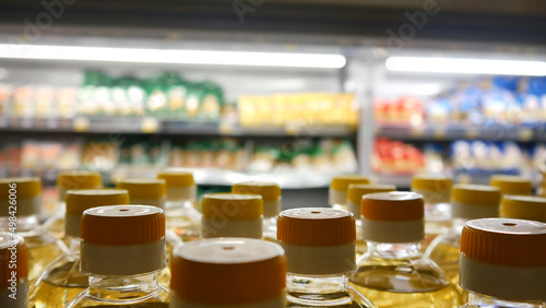 Close-up of many sunflower oil bottles on a store shelf