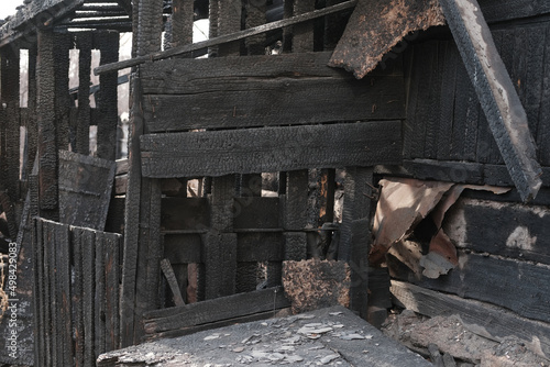 House destroyed by fire. Burnt wooden house.