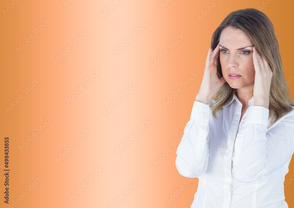 Stressed caucasian woman holding her head against copy space on orange gradient background Stressed caucasian woman holding her head against copy space on orange gradient background