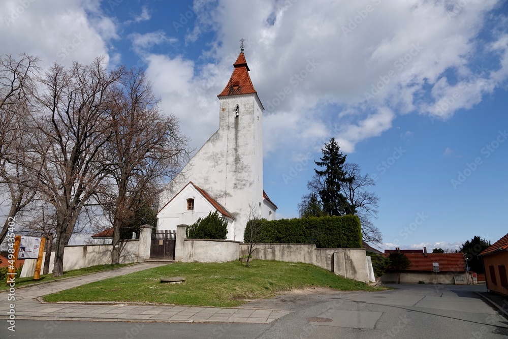 Fototapeta premium Church of the Nativity of St. John the Baptist, built in Romanesque style with a Baroque extension. In the village of Hovorcovice near Prague. High quality photo