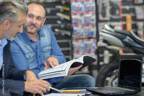 motorbike dealer having a conversation with the customer photo