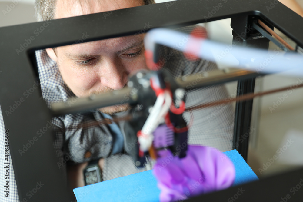 An engineer controls the machine. Layer-by-layer 3D printing of a polymer plastic part. Sample production An engineer controls the machine. Layer-by-layer 3D printing of a polymer plastic part. Sample production