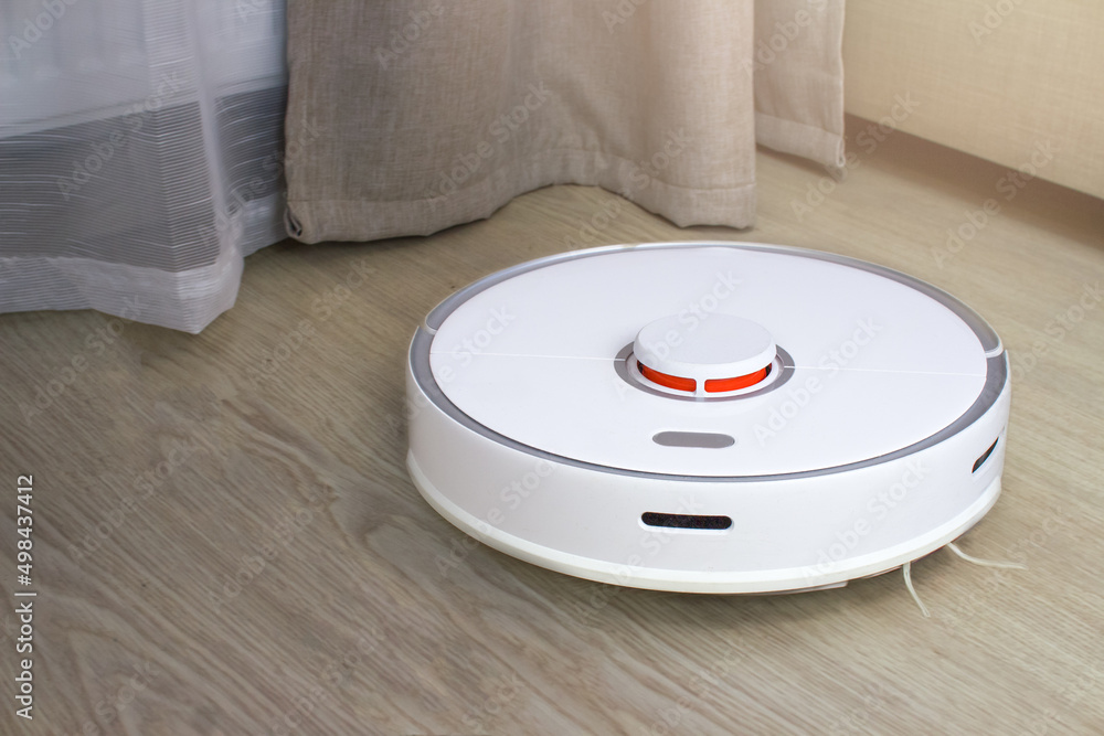 Cleaning the apartment with a robot vacuum cleaner. Automatic floor washing. Cleaning the apartment with a robot vacuum cleaner. Automatic floor washing.