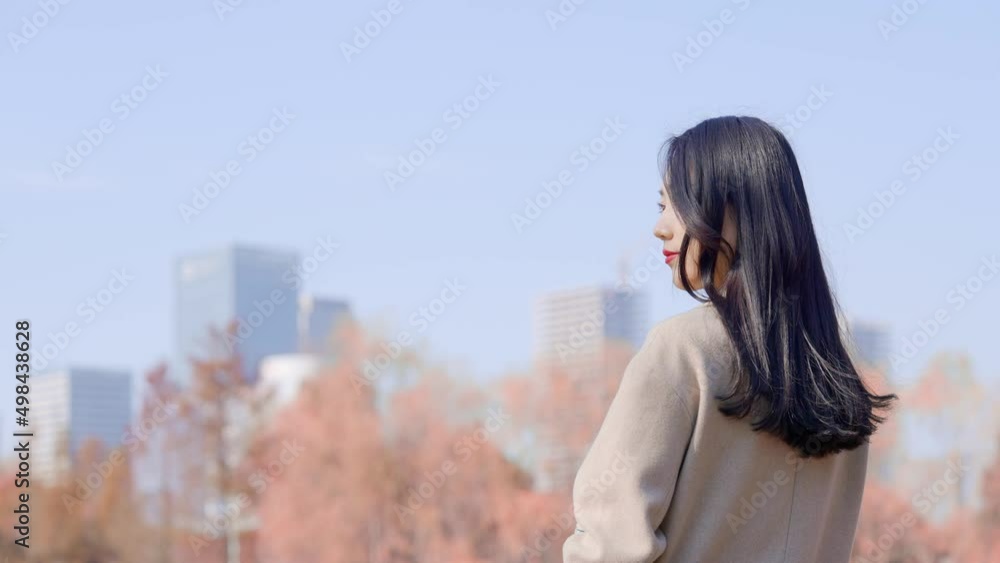 young beautiful woman standing in city park
young beautiful woman standing in city park